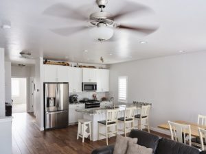 a-clean-white-kitchen-with-a-ceiling-fan